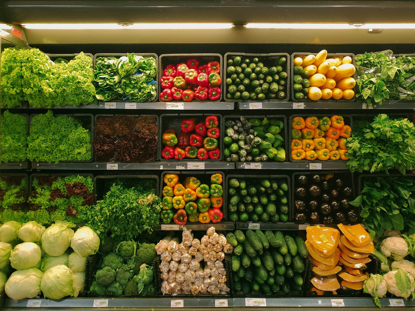 Shop shelves of fresh goods under the lights.